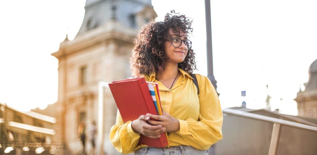 Finance Intern Woman In Yellow Jacket Holding Books