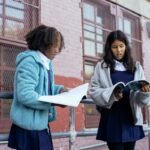 SAYouth.mobi: Teacher Assistant Online Application 3 girls discussing new textbooks near school